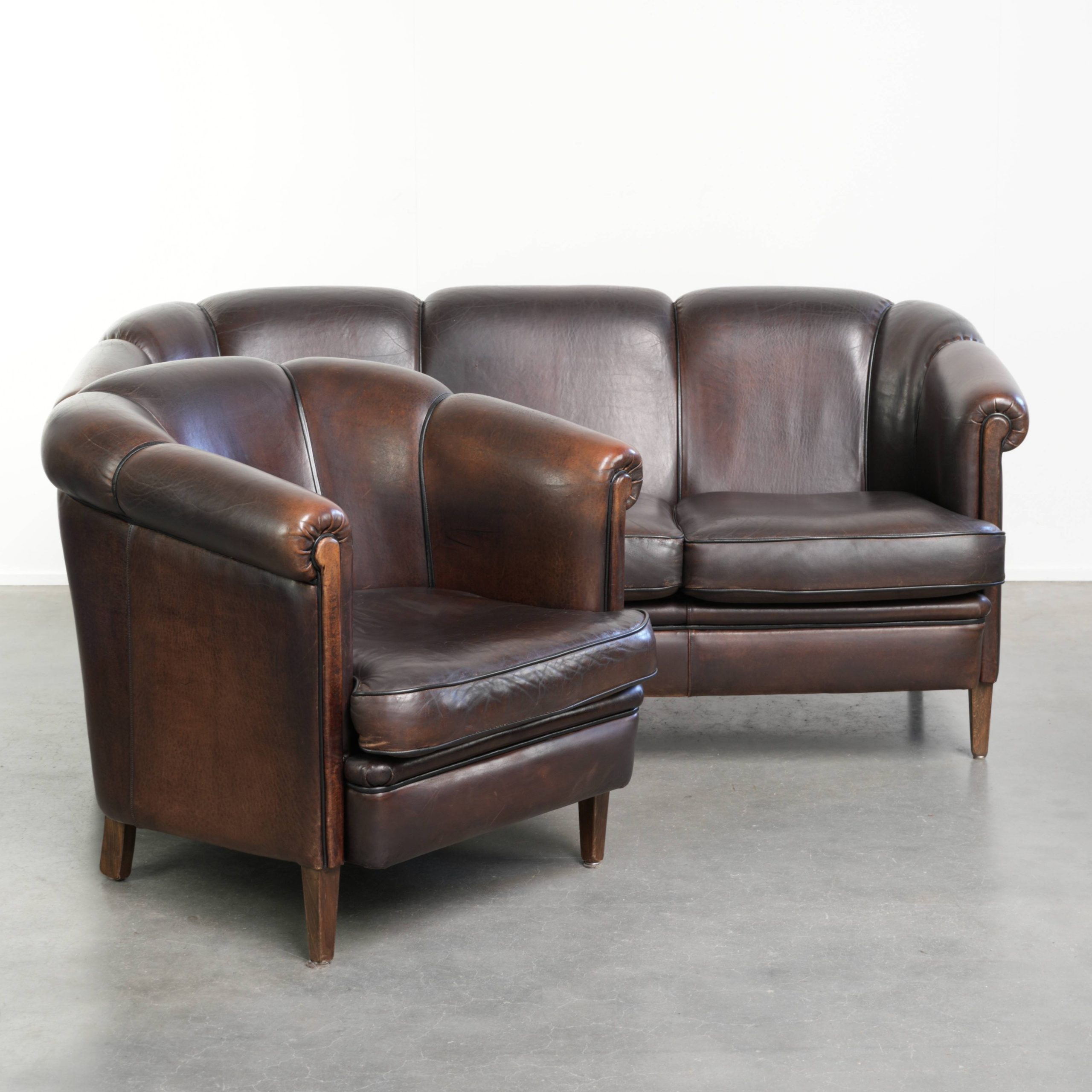 Prachtige set van een schapenleren bankstel samen met zijn bijpassende clubfauteuil met een luxe voorkomen