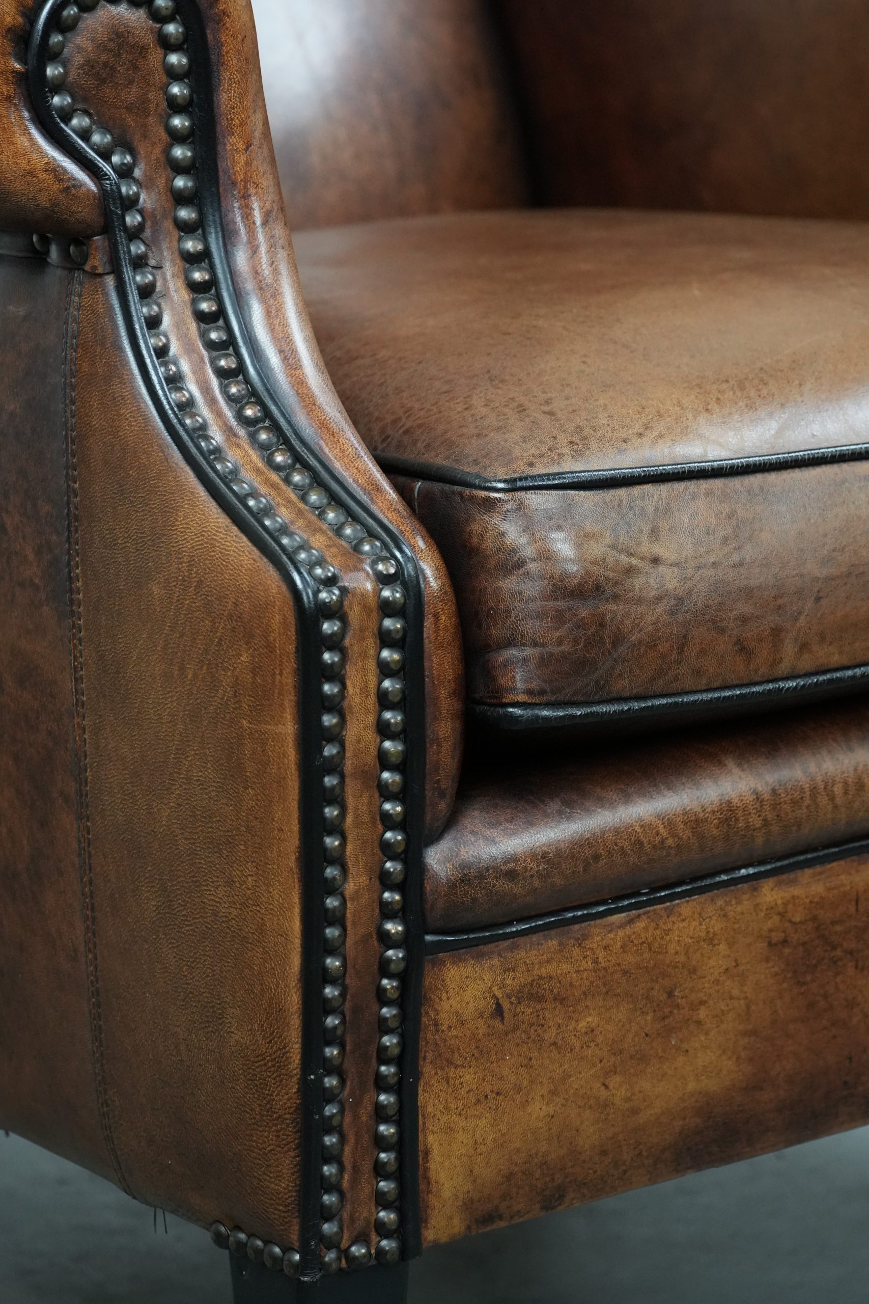 Tijdloze en comfortabele schapenleren oorfauteuil met mooie kleuren en een afwerking met siernagels en zwarte biezen - Afbeelding 11