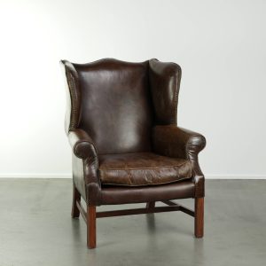 Comfortabele en karaktervolle rundleren oorfauteuil met een luxe uitstraling